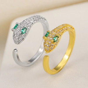 Gold and silver serpent head open rings with pavé cubic zirconia and green gem eyes