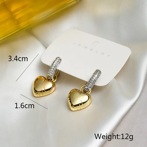 Macro view of gold heart drop earrings with dimensions 3.4cm and weight 12g details