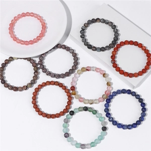 Flat lay of 8mm natural stone bead bracelets in various colors on white backgrounds