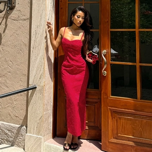 Red backless ruched maxi dress with textured jacquard fabric in an outdoor setting