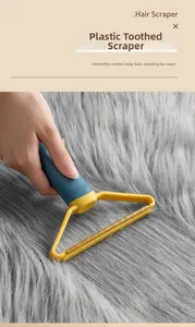 Close-up of dual-purpose pet hair scraper with serrated head cleaning grey carpet fabric