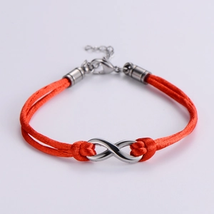 Detailed view of handmade orange cord bracelet with silver infinity symbol and lobster clasp