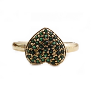 Close-up of heart-shaped ring in gold finish with micro-paved green cubic zirconia gems