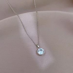 Close-up of a silver titanium steel necklace featuring a brilliant round cubic zirconia pendant