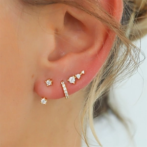 Close-up of gold S925 silver earring set with marquise diamonds on model's ear