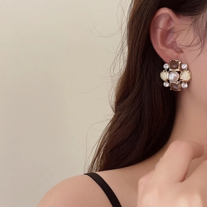 French vintage floral earrings with pearls and crystals on a female model