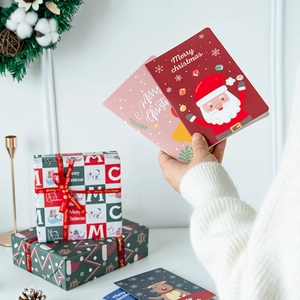 Handheld festive Merry Christmas card with vibrant red design and high-quality paper texture
