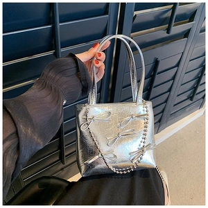 Silver mini handbag with metallic pleats, bow details, and delicate beaded chain