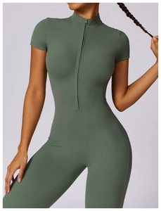 Detail of dark green zipper yoga bodysuit showing smooth moisture-wicking fabric