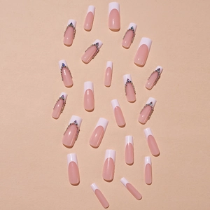Extra long square French press-on nails with nude pink base and V-shaped crystal rhinestones