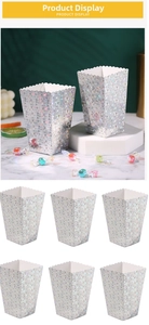 Close-up of silver popcorn boxes with star sequins and scalloped edges for parties