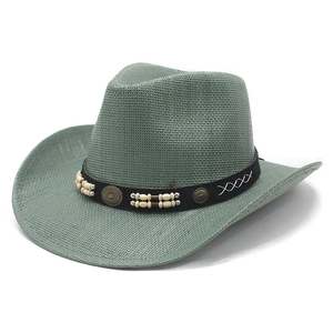 Sage green Western straw cowboy hat with ethnic beaded band and wide brim on white backdrop