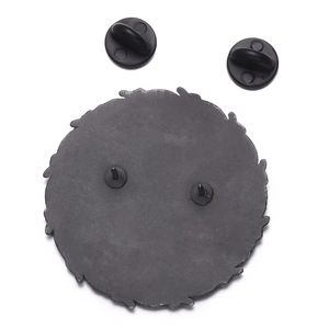 Detailed back view of dark metal skull badge featuring double needles and rubber clutches
