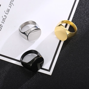 Three men's oval signet rings in silver, gold, and black steel on a modern background