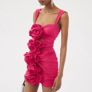 Detail of 3D rose flower accents and ruched texture on a vibrant hot pink mini dress