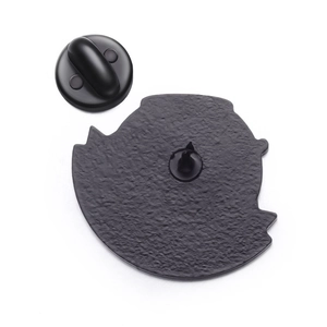 Detailed close-up of the black metal brooch back with a secure rubber clutch backing