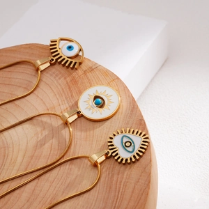 Vintage Turkish evil eye necklaces in gold-plated steel on a wooden display