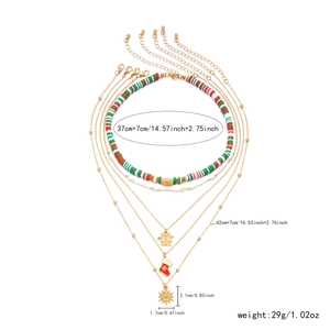 Detail of Christmas multi-layer necklace with clay beads and festive holiday charms