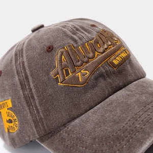 Close-up of heavy embroidery and washed cotton texture on a vintage baseball cap