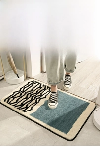 Detail of plush anti-slip bathroom mat with blue and white abstract wavy patterns