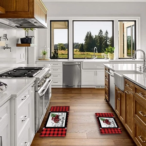 Detail view of 2-piece red buffalo plaid Christmas kitchen mats with festive truck print