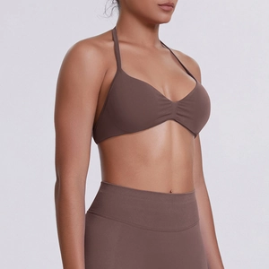 Detail of seamless chocolate brown sports bra with halter straps and ribbed texture