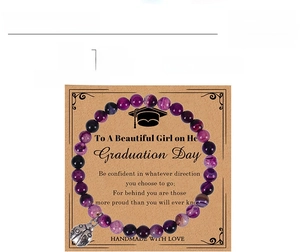 Detail of purple striped agate beaded bracelet with ladybug charm on graduation card