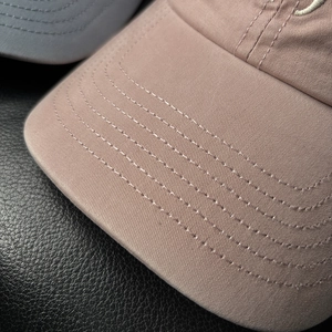 Close-up of baseball cap featuring refined stitching and premium cotton twill texture