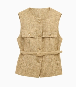 Detail of gold tweed vest with decorative embossed metal buttons and matching belt