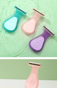 Detail of ergonomic portable razors for women with protective caps in various pastel colors
