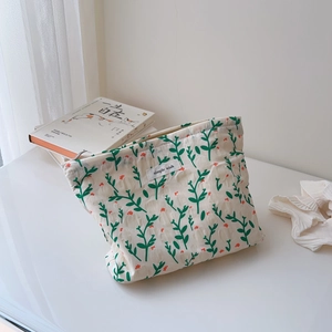 Detailed view of floral cotton toiletry bag with zipper and simple wish label