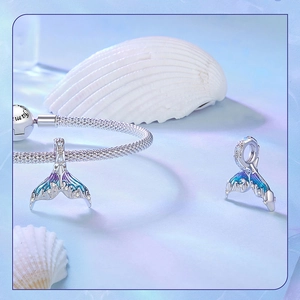 Close-up of S925 silver mermaid tail charm with gradient enamel and zircon on bracelet