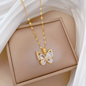 Macro view of butterfly pendant with clear zircons on gold plated stainless steel chain