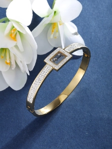 Detailed close-up of golden rhinestone bangle featuring Forever Love inscription