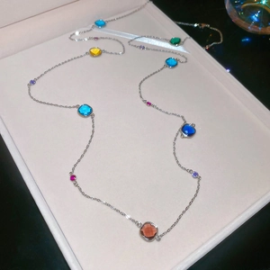 Detail of multi-colored faceted crystals and pearls on a silver-tone necklace