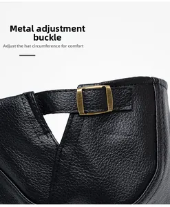 Detail view of black faux leather beret featuring adjustable bronze metal buckle