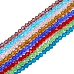 Colorful faceted glass crystal bicone beads arranged in rows for DIY jewelry making