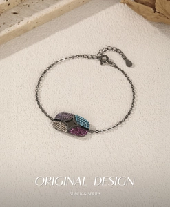 Macro shot of S925 silver black star bracelet with colorful gemstones and oval plate