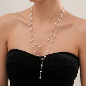 Elegant double-layered Y-shaped pearl necklace with silver chain on female model