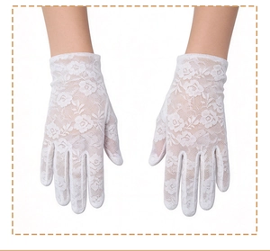 Close-up detail of white floral lace gloves with delicate embroidery and scalloped edges
