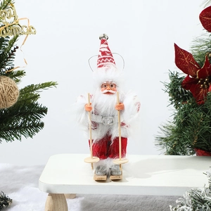 Close-up of a Santa doll with wooden skis and fabric clothes on a festive background