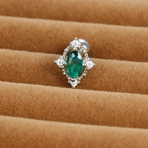 Detail of vintage earring with oval green zircon stone and silver beaded edges