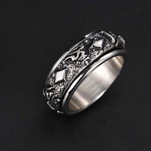 Macro view of vintage stainless steel spinner ring with embossed Sanskrit symbols