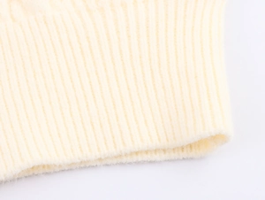 Macro shot of cream knit ribbed texture showing soft fleece-like material and quality fabric