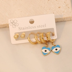 Three-pair stainless steel earring set featuring gold hoops with blue evil eye heart charms