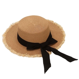 Women's straw boater sun hat with black ribbon bow and fringed brim for beach summer travel