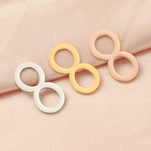 Polished stainless steel infinity symbol charms in silver, gold, and rose gold finishes