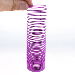Macro detail of flexible purple plastic spring toy showing elastic spiral structure and texture