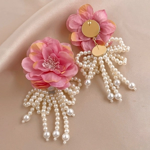 Elegant pink fabric flower earrings with white faux pearl tassels on champagne silk