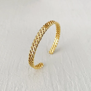 Elegant gold plated brass open knot bracelet with a minimalist twisted woven texture design